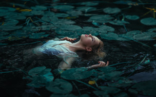 Woman floating lily pads water - closed free wallpaper