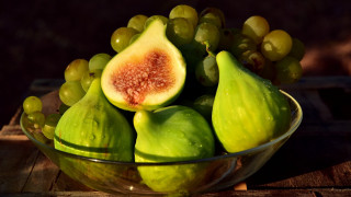 Bowl fruit grapes wooden table - a bowl of fruit free wallpaper
