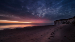 Beach cliff sunset pink blue - rich moody colour free wallpaper