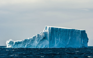 Iceberg ocean boat sky mountain - a large iceberg free wallpaper