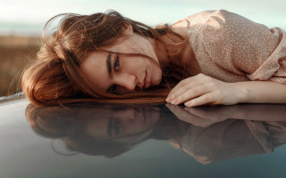 Woman laying on car hood - the hood of a car free wallpaper