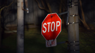 Stop sign pole night house - a house in the background free wallpaper