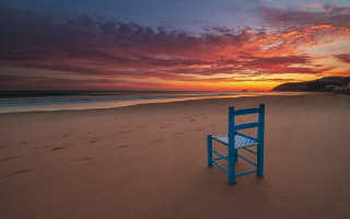 Blue beach chair sunset ocean - sandy free wallpaper
