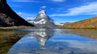 Mountain reflection lake beach sky 3 - the still water of a lake free wallpaper