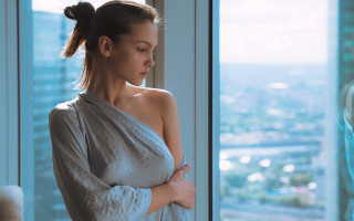 Woman white dress window cityscape - natural light free wallpaper