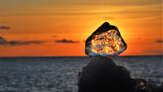 Glowing rock sunset ocean orange - orange sky free wallpaper