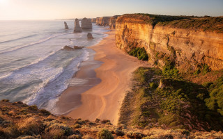 Beach cliff water sunset mountains - a few person free wallpaper