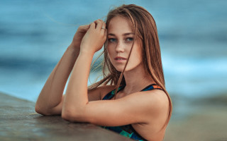 Woman bikini ocean horizon portrait - her arm behind her head free wallpaper