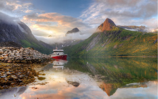 Docked boat mountains clouds sunset - a mountain range in the background free wallpaper