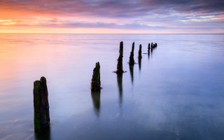 Wooden posts water sunset cloudy - rich moody colour free wallpaper
