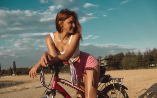 Woman bike beach sand water - a body of water and trees free wallpaper