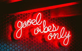Neon sign good vibes honeycombs - side of a building free wallpaper