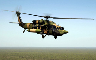 Military helicopter over field blue - a military helicopter free wallpaper