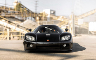 Black sports car factory rubble - a parking lot next free wallpaper