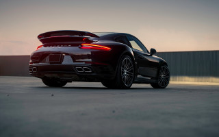 Black sports car sunset rearlights - a parking lot free wallpaper