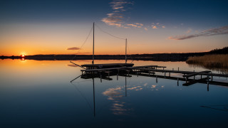 Docked boat sunset reflections mountain - the distance free wallpaper