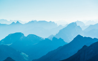 Mountain range blue sky clouds 7 - a view of a mountain range free wallpaper