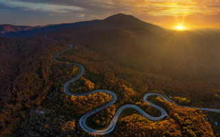 Winding road forest sunset mountain - a mountain in the distance free wallpaper