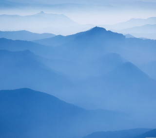 Mountain range foggy day plane - a plane in the foreground free wallpaper