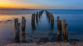 Pier beach ocean sunset boat - a boat in the distance free wallpaper