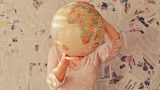 Woman globe wall of newspapers - a map free wallpaper