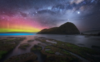 Aurora borealis water rocks grass - over a body of water free wallpaper