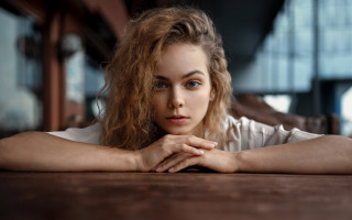 Woman long hair sitting table 2 - free portrait wallpaper