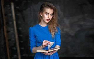 Surprised woman blue dress reading - look free wallpaper for desktop