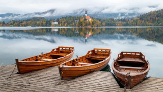Wooden boats dock lake church - a church in the background free wallpaper