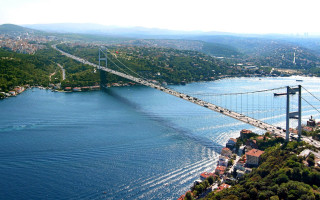 Bridge water city foreground background 2 - a city in the background and a bridge in the foreground free wallpaper