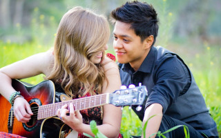 Man woman grass guitar playing - a guitar free wallpaper