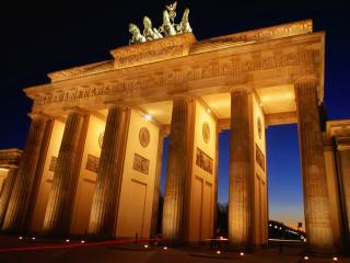 Large building columns statues nighttime - the side of the building free wallpaper