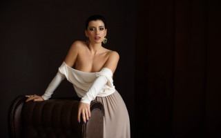 Woman white top brown chair - a white top free wallpaper
