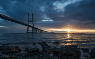 Sunset bridge water mountain city - a large bridge free wallpaper