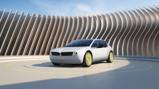 White car driving curved building - a road next free wallpaper