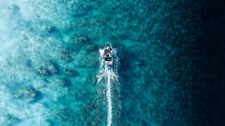 Boat water shore rocks corals - near free wallpaper