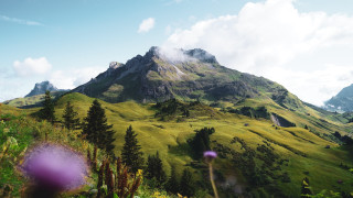 Mountain grassyfield trees clouds nature - a grassy field below free wallpaper
