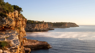 Cliff water mountains city sunset - a cliff face free wallpaper