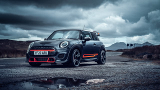 Small car mountains cloudy sky - a small car free wallpaper