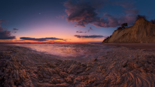 Sunset beach waves cliff dusk - a sunset over a beach free wallpaper