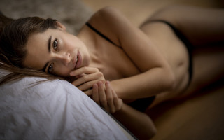 Woman lying bed blurry portrait - her chest free wallpaper