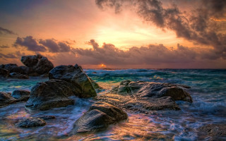 Sunset ocean rocks cloudy sky 6 - a sunset over the ocean free wallpaper