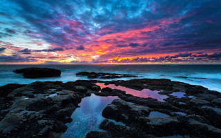 Colorful sunset ocean rocks water - a large rock free wallpaper