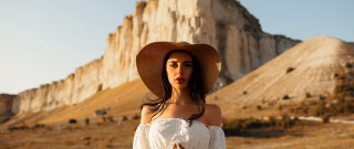 Woman hat mountain beach sand - a mountain in the background and a sky free wallpaper
