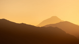 Mountain range bird sunset hazy - a hazy sky in the background free wallpaper