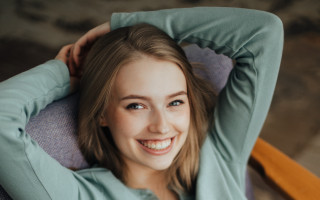 Woman smiling blonde portrait stock - her arm behind her head free wallpaper