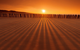 Beach fence sunset person sand - crepuscular ray free wallpaper