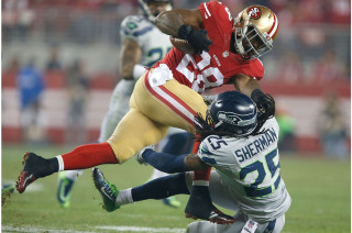 Football player tackled game field - a crowd watching free wallpaper