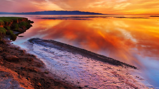Sunset water island mountain city - a sunset over a body of water free wallpaper