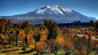 Mountain river trees bridge city - a blue sky in the background free wallpaper for desktop